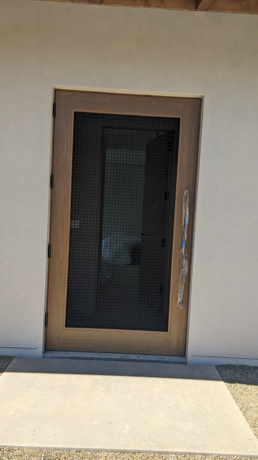 Custom wood entry door installation by Shalom Construction